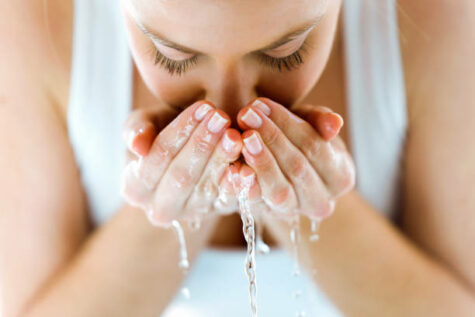 WOMAN WASHING FACE