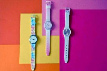 Three colorful wrist watches on bright background